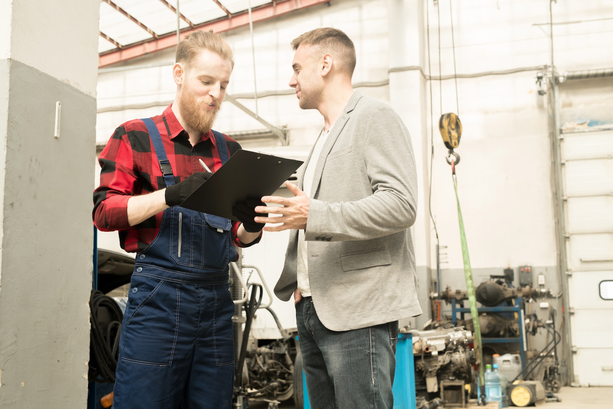 Car Technician Talking To Client